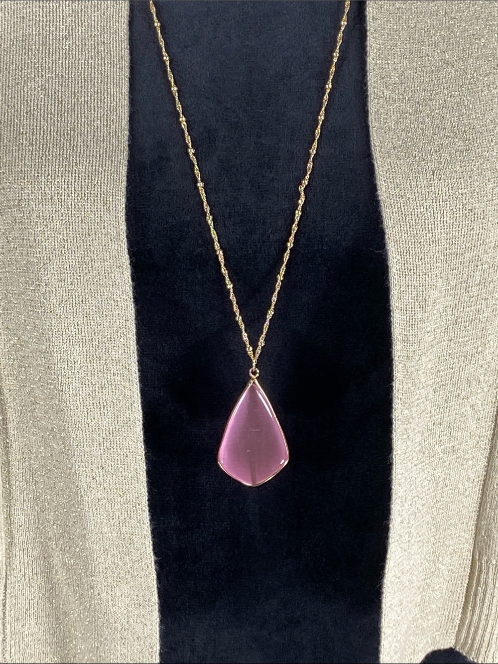 Gold-tone chain with a smooth lavender pink teardrop pendant. Elegant, feminine